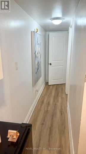 Toronto (Keelesdale-Eglinton West) apartment for rent - A hallway with a white door and a painting on the wall.