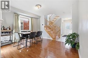 Oakville townhouse for rent - A dining room with a wooden table and chairs.