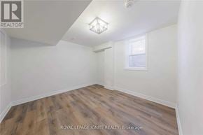 Clarington (Bowmanville) apartment for rent - A room with wooden flooring and white walls.