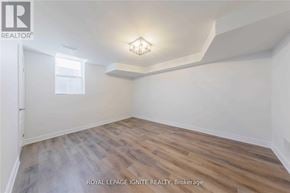 Clarington (Bowmanville) apartment for rent - A room with wooden flooring and a light fixture on the ceiling.