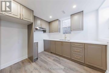 Clarington (Bowmanville) apartment for rent - A kitchen with beige cabinets and a white countertop.