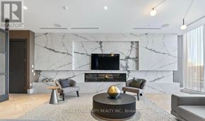 Oshawa (Windfields) condo for rent - A modern living room with a marble wall and a flat screen TV.