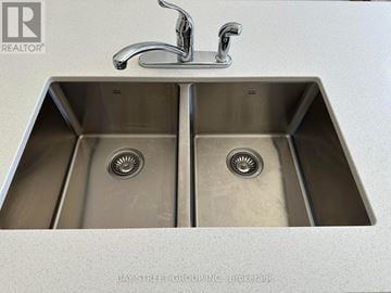 Vaughan (Vellore Village) townhouse for rent - A double sink in a kitchen with a faucet above it.