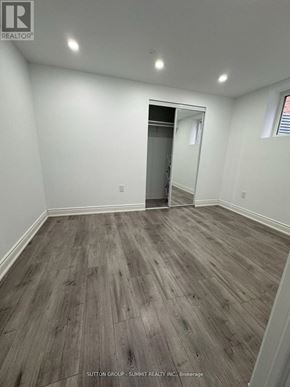 Milton (Co Coates) apartment for rent - A room with wood flooring and a doorway leading to another room.