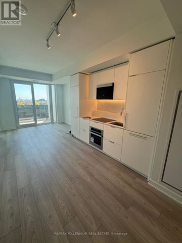 Mississauga (Mississauga Valleys) condo for rent - A modern kitchen with white cabinets and a wooden floor.