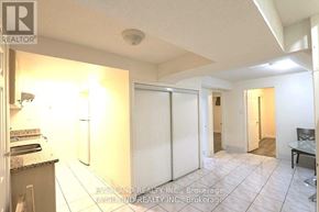 Toronto (Agincourt North) apartment for rent - A realtor photo of a kitchen with a refrigerator, sink, and a dining table.