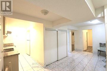 Toronto (Agincourt North) apartment for rent - A realtor photo of a kitchen with a refrigerator, sink, and a dining table.