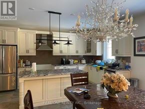Aurora apartment for rent - A kitchen with a table and chairs in the foreground and a chandelier hanging from the ceiling.