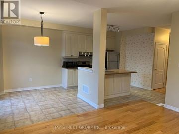 Markham (Wismer) townhouse for rent - A kitchen with a countertop and cabinets is shown in this image.