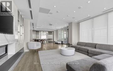 Toronto (Newtonbrook East) condo for rent - A modern living room with a grey sofa and a white coffee table.