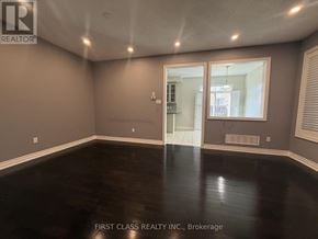 Markham (Cathedraltown) townhouse for rent - A spacious living room with a fireplace and a skylight.
