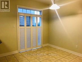 Markham (Cathedraltown) townhouse for rent - A room with a sliding door and a light on the ceiling.