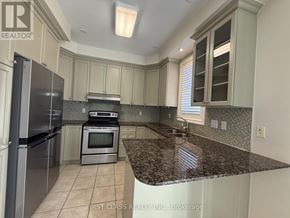 Markham (Cathedraltown) townhouse for rent - A bathroom with a tub, toilet, and sink.