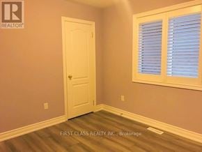 Markham (Cathedraltown) townhouse for rent - A room with a white door and a window with blinds.