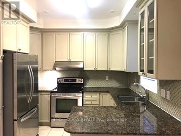 Markham (Cathedraltown) townhouse for rent - A kitchen with a refrigerator, microwave, oven, sink and cabinets.