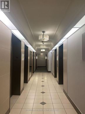 Toronto (Woburn) condo for rent - A long hallway with doors on both sides and a sign on the wall.