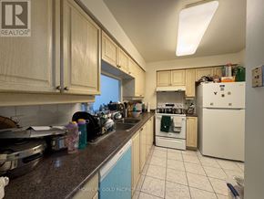 Toronto (Woburn) condo for rent - A kitchen with a refrigerator, dishwasher, and oven.