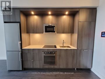Toronto (Banbury-Don Mills) condo for rent - A modern kitchen with wooden cabinets and stainless steel appliances.