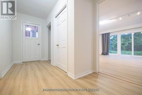 Toronto (Newtonbrook West) apartment for rent - A room with a door and a window with a view of trees.