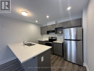 Ottawa townhouse for rent - A kitchen with a stainless steel refrigerator and a white countertop.