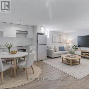 Toronto (Danforth Village-East York) apartment for rent - A modern kitchen with white appliances and a dining table set for four.