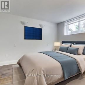 Toronto (Danforth Village-East York) apartment for rent - A bedroom with a bed, pillows, and a window.