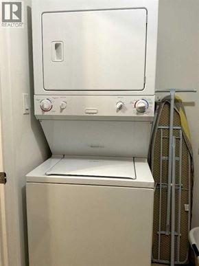 Lloydminster apartment for rent - A white dishwasher with a silver handle is in a room.