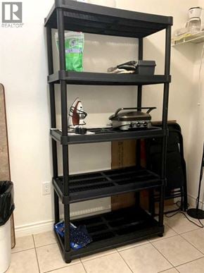 Lloydminster apartment for rent - A black shelving unit with various items on it.