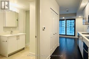 Ottawa condo for rent - A modern kitchen with white cabinets and a large window.