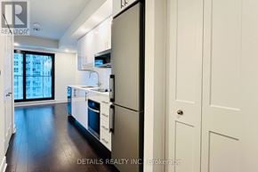 Ottawa condo for rent - A modern kitchen with white cabinets and a stainless steel refrigerator.