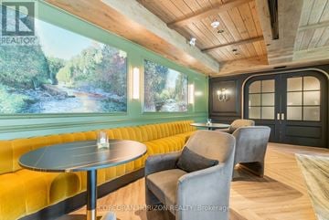 Centre Wellington (Elora/Salem) condo for rent - A living room with a yellow couch and a round table.