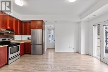 Mississauga (Churchill Meadows) townhouse for rent - A kitchen with wooden cabinets and stainless steel appliances.