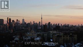 Toronto (Yonge-St. Clair) house for rent - A cityscape with buildings and a tower in the background with EXP REALTY Brokerage written on the bottom.