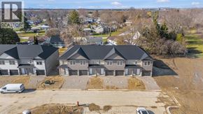 Chatham townhouse for rent - A real estate company's logo is watermarked on an aerial photo of a residential area with houses and construction.