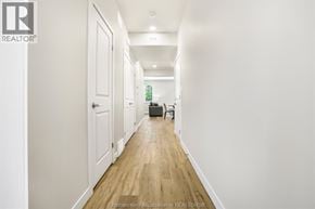 Chatham townhouse for rent - A long hallway with a brown rug on the floor.