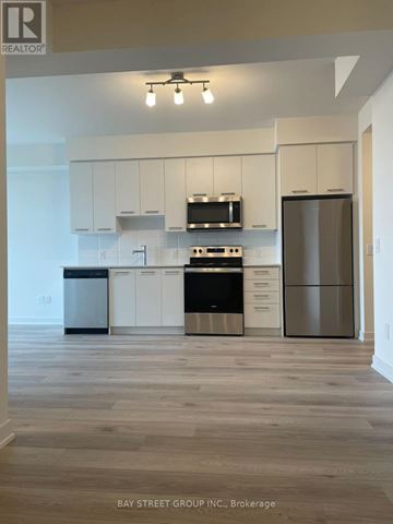 Grimsby (Grimsby Beach) condo for rent - A kitchen with white cabinets and a wooden floor.