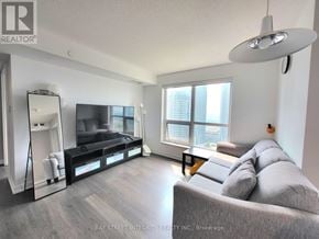 Toronto (Agincourt South-Malvern West) condo for rent - A living room with a grey couch and a flat screen TV.