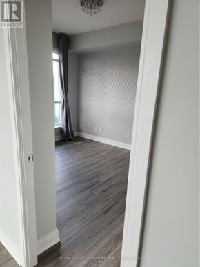 Toronto (Agincourt South-Malvern West) condo for rent - A room with a grey carpet and a chandelier.