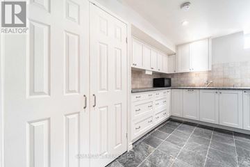 Mississauga (Clarkson) apartment for rent - A kitchen with white cabinets and a microwave built into the counter.