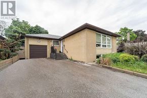 Mississauga (Clarkson) apartment for rent - A house with a brown roof and a driveway in front of it.