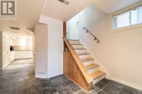 Mississauga (Clarkson) apartment for rent - A staircase with a wooden handrail and white walls.