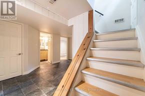 Mississauga (Clarkson) apartment for rent - A staircase with wooden steps and a metal handrail.