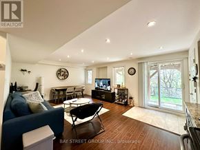 Richmond Hill (Oak Ridges Lake Wilcox) apartment for rent - A living room with a blue couch and a television.