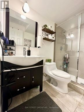 Richmond Hill (Oak Ridges Lake Wilcox) apartment for rent - A white toilet is in a bathroom with a sink and mirror.