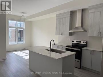 Richmond Hill townhouse for rent - A kitchen with a sink and stove top oven.