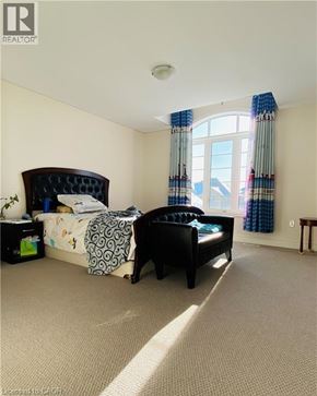 Hamilton apartment for rent - A bedroom with a large bed and a window with curtains.