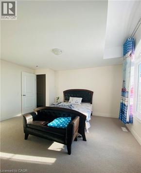 Hamilton apartment for rent - A bedroom with a bed and a chair.