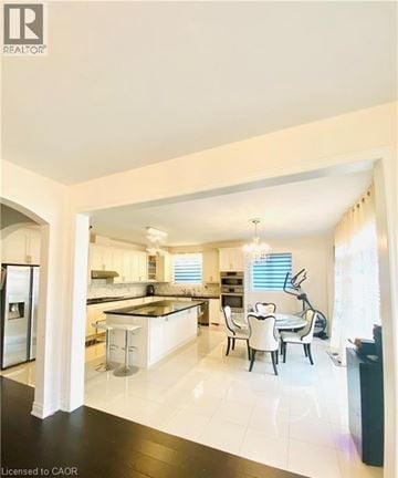 Hamilton apartment for rent - A modern kitchen with white cabinets and black countertops.