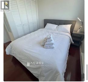 Richmond apartment for rent - A neatly made bed with white bedding and a white pillow.