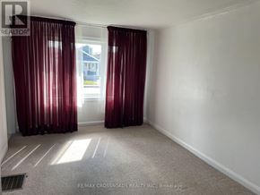 Toronto (Woodbine-Lumsden) apartment for rent - A room with red curtains and a carpeted floor.